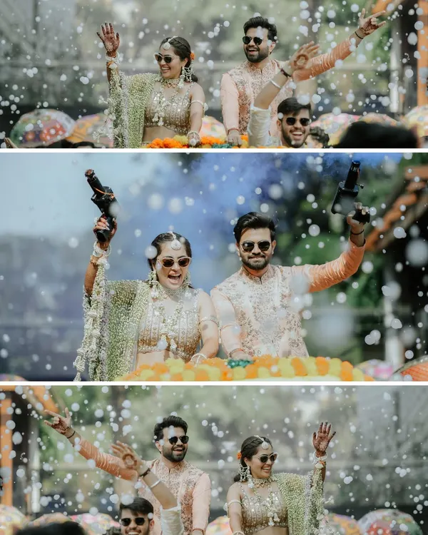 Making a grand and fun entrance at the Haldi. We love capturing high-energy moments like this, complete with sunglasses and money guns, that show the couple's fun side.
