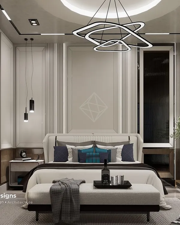 This master bedroom is a perfect example of how I create serene and sophisticated retreats. I used a calm palette of cream, gray, and wood, combined with clean lines and layered lighting from the geometric chandelier and pendants to build a polished, elegant look.