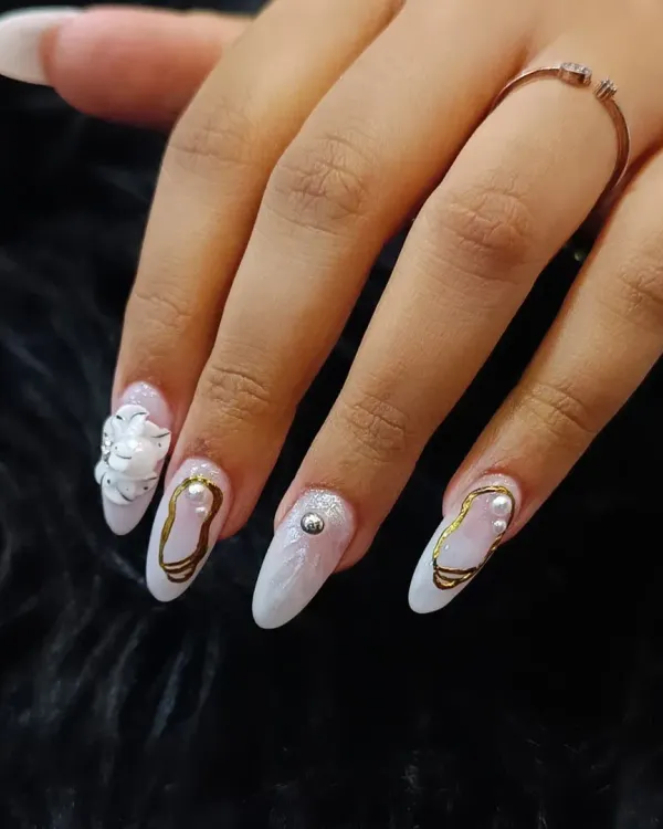 Experience the pinnacle of nail artistry with our signature 3D sculpted designs. This elegant almond-shaped set features delicate white 3D flowers, lustrous pearls, and fine gold detailing over a marbled base, creating a look of pure sophistication perfect for bridal events or any special occasion.