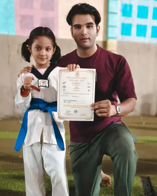 A proud moment with one of my young champions, Zainab Shaikh, as she receives her blue belt certificate. Her hard work and dedication have paid off.