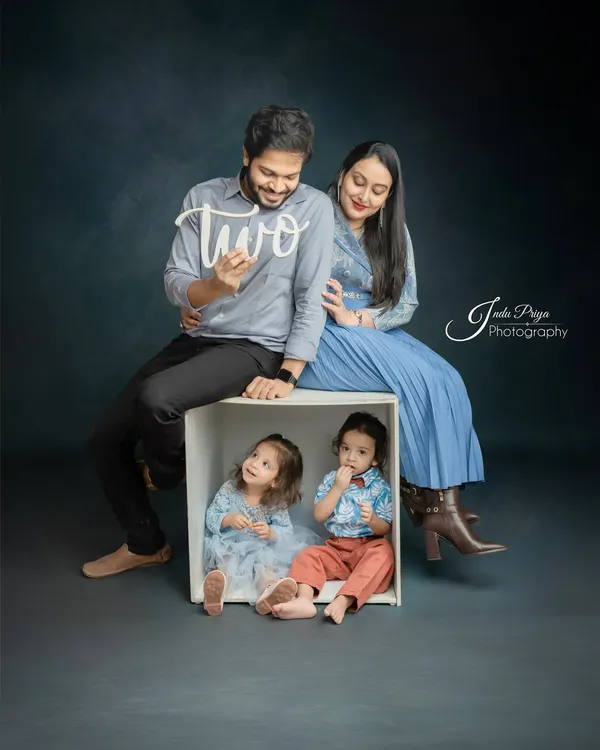 A creative family portrait celebrating the twins' second birthday. Using my signature box prop, I can create dynamic compositions that include the whole family in a fun and modern way.