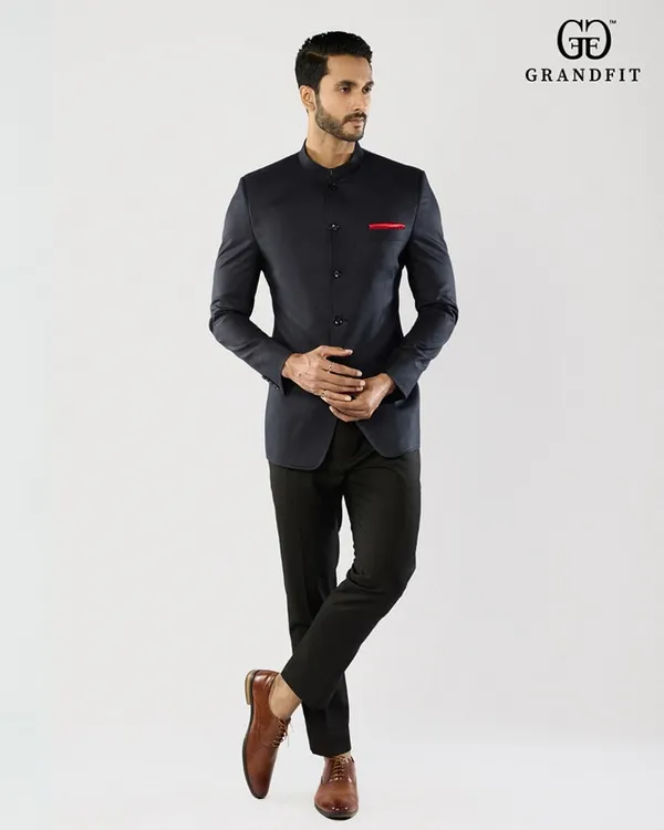 A full-length view of our bespoke navy Jodhpuri suit. The sharp, clean silhouette and mandarin collar offer a powerful and elegant statement for any formal occasion.