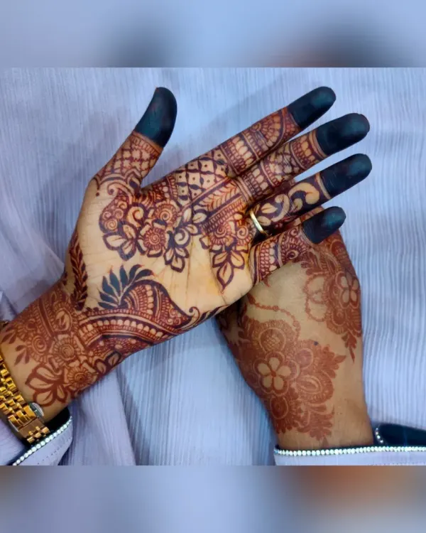 A classic party henna design with floral patterns and filled fingertips. This is a popular choice for festivals and celebrations.