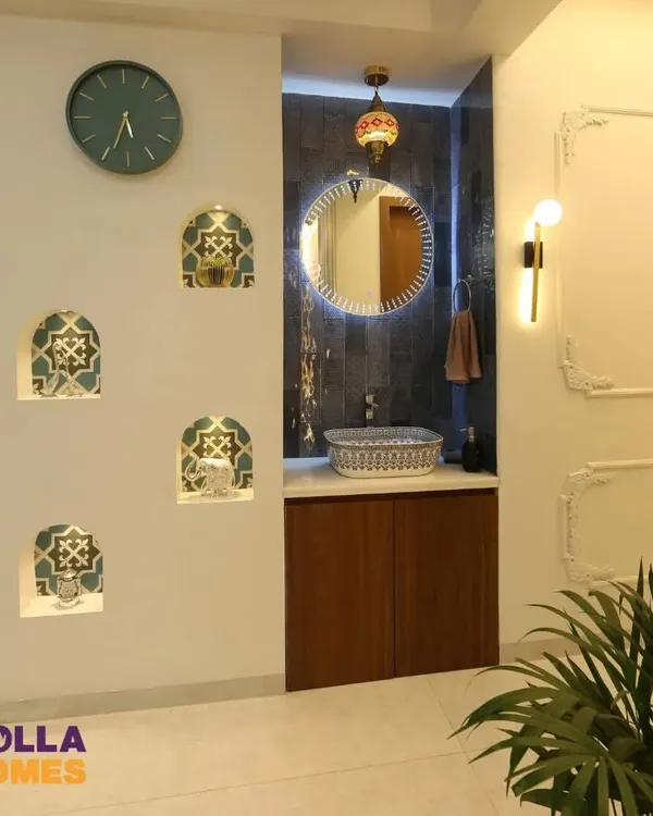 This wash basin area features a Persian theme with a beautiful printed basin, a Turkish-style lamp, and decorative niches with patterned tiles, creating a rich and exotic look.