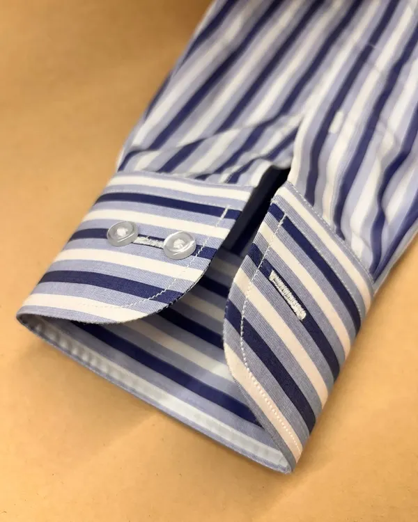 The cuff of a bespoke shirt is a mark of quality. This example, made from Thomas Mason fabric, features a classic two-button design and precise stitching for a sharp finish.