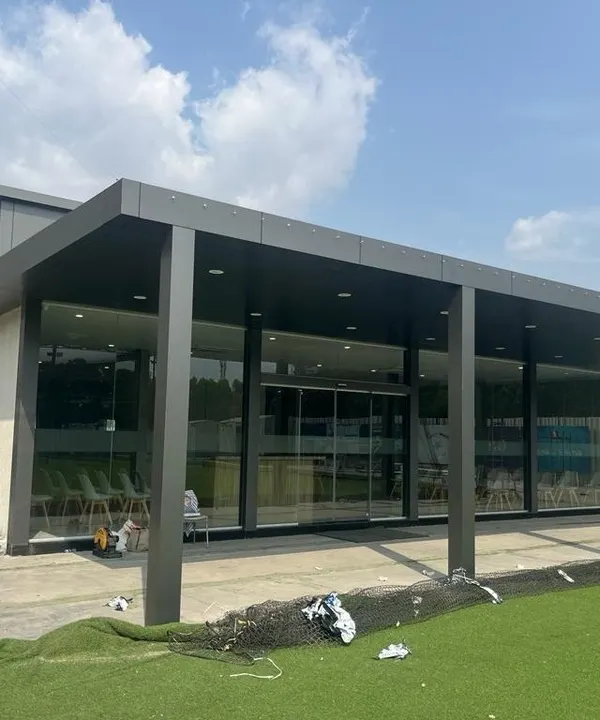 This is a large prefab administrative office building I constructed. It features a modern design with a covered entryway and extensive glass walls, providing a professional and comfortable workspace that can be assembled much faster than a traditional building.