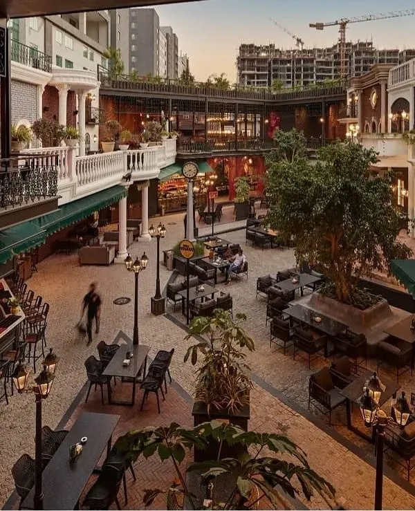 This is the courtyard of Street 1522 in Sarjapur, a project where I designed the complete landscape to create a European-style street atmosphere. The design focuses on creating multiple distinct seating zones, using classic lamp posts for ambient lighting and integrating greenery to soften the hardscape, making it an inviting space for evening crowds.