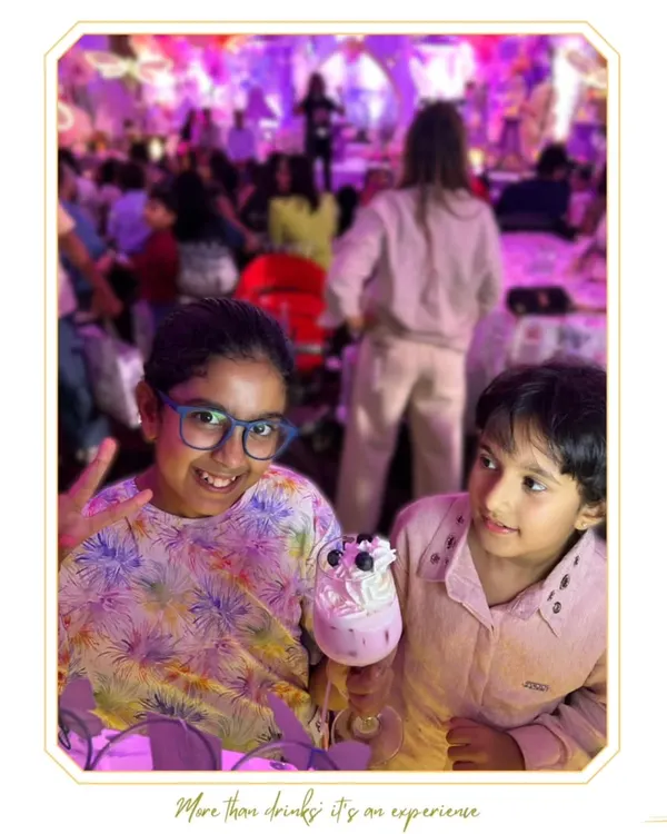 Our mocktail bar is a hit with the little VIPs. Here, two young guests enjoy a fun, whipped-cream-topped drink designed just for them.