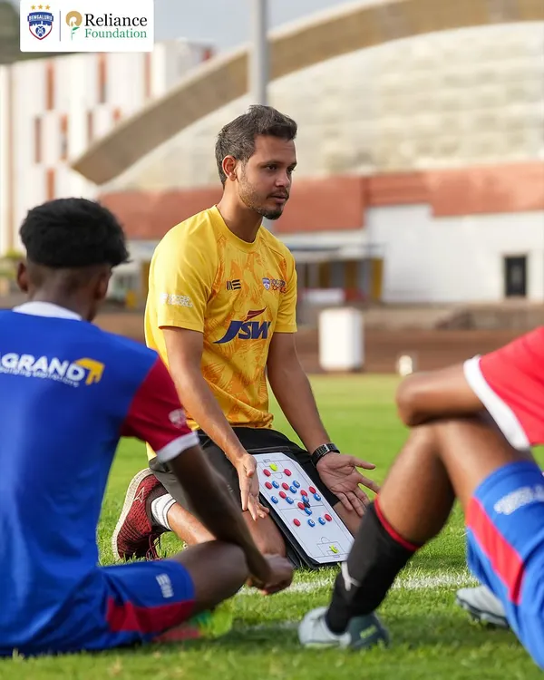 A coach uses a tactics board to explain formations and player movement to our U19 squad. We believe in developing intelligent players who understand the 'why' behind every drill and strategy.