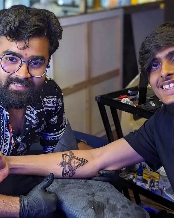 Sharing a proud moment with a client after finishing his custom geometric eagle tattoo. Seeing the satisfaction on a client's face is the best part of my job.