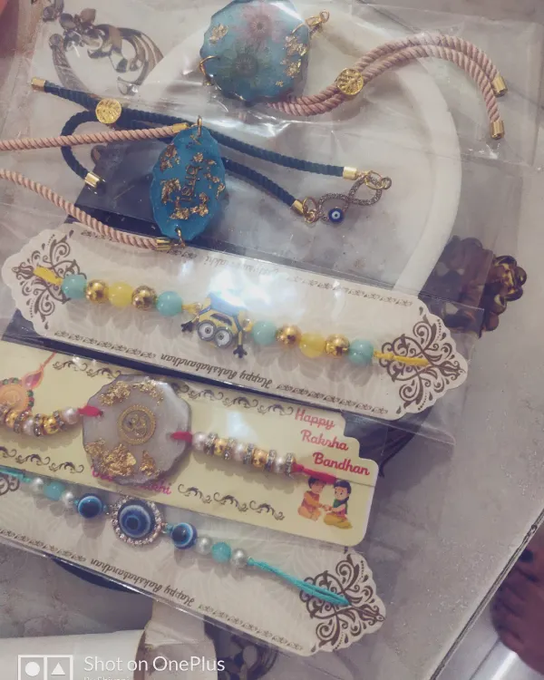 A selection of my custom resin rakhis, perfect for Raksha Bandhan. These are designed to be keepsakes, with options like gold-flecked resin and beaded evil eye bracelets.