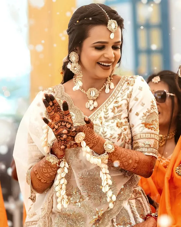 A happy bride during her Haldi ceremony, adorned with beautiful seashell jewellery that I provided. The look is fresh, bright, and perfect for the occasion.