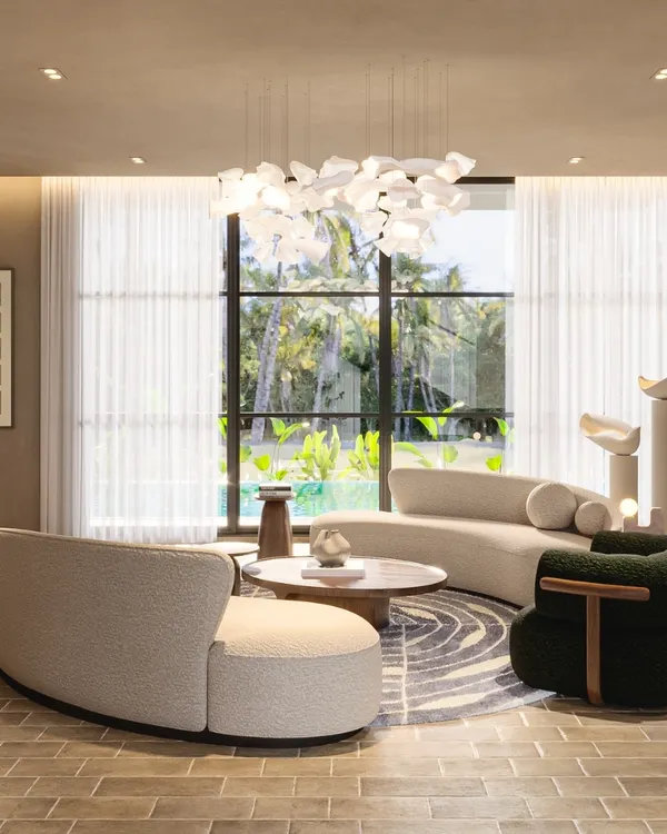 The central conversation area at the Siroi Lilly villa is a study in balanced comfort. I paired the inviting texture of bouclé couches with a soothing beige palette and a delicate, sculptural chandelier to create a space that is peaceful, functional, and beautiful.