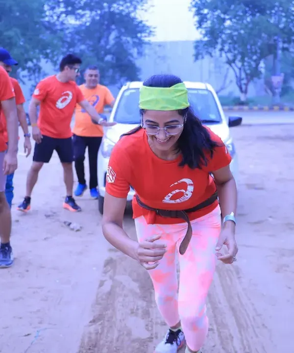 A participant showing her strength by pulling a car during our Coach's Fitness Challenge. We push boundaries and redefine what's possible.