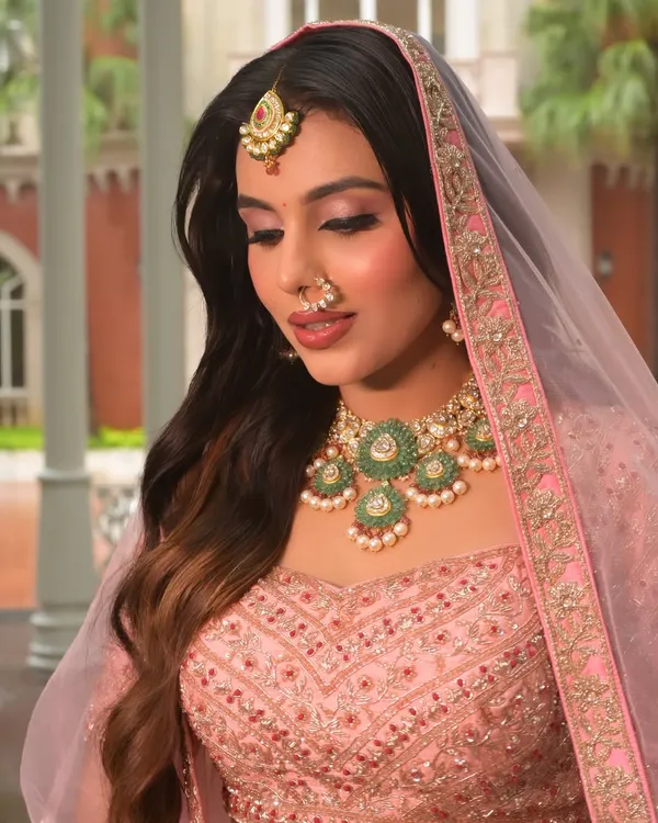 A dreamy and romantic engagement look. The soft pink makeup is enhanced by the delicate veil, creating an ethereal glow that is perfect for celebrating your special moment.