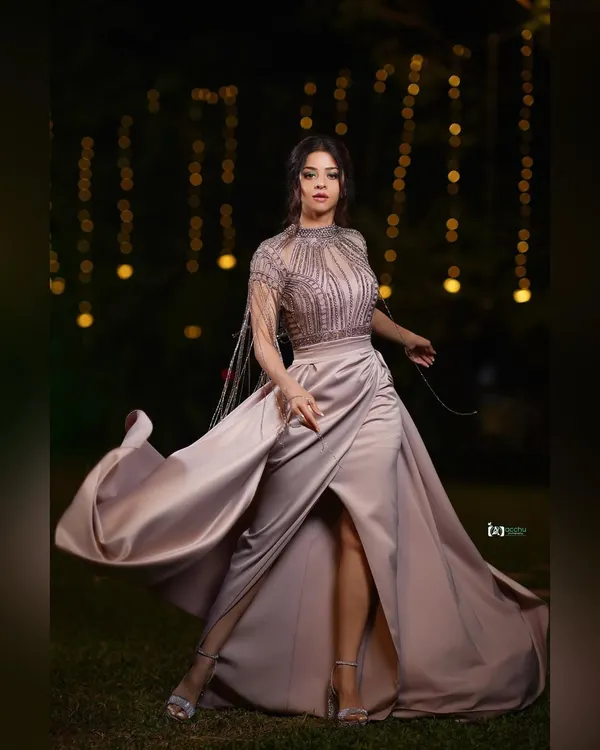 Capturing movement is key to a dynamic shot. The flowing fabric of this satin gown against the soft bokeh of the background lights creates a sense of drama and elegance for this red carpet look.
