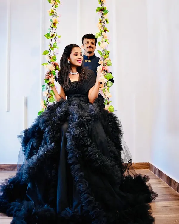 A stunning black ruffled gown perfect for a dramatic pre-wedding or couple's shoot. This dress makes a bold statement and looks incredible in my floral swing setup.
