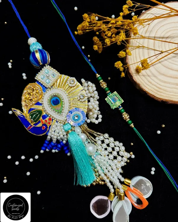 An exquisite peacock Lumba rakhi paired with a simpler, matching thread for your brother. The intricate beadwork and vibrant colors make this a standout piece for the festival.
