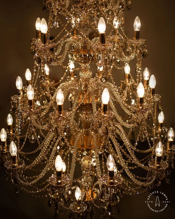 A detailed look at our magnificent multi-tiered crystal chandelier. Each arm is draped with shimmering crystal beads that reflect and refract light, creating an unparalleled sparkle. This fixture is a testament to classic European design and meticulous craftsmanship.