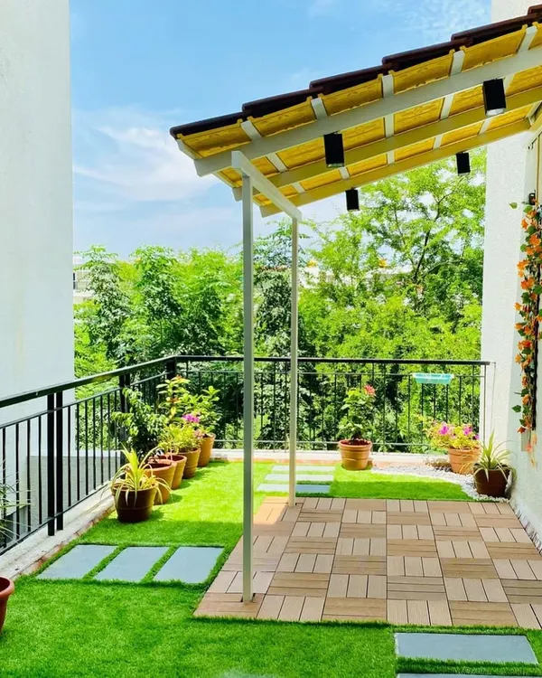 A perfect example of a balcony makeover. We used artificial turf, a wooden deck area, and a simple pergola with lights to turn this into a beautiful and functional outdoor space for a young family.