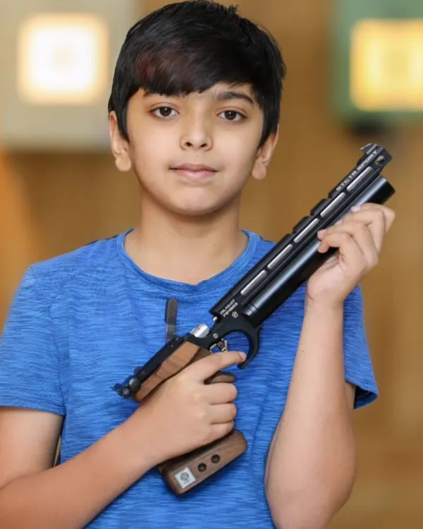 I believe in starting young to build a foundation of focus and discipline. Here, a young shooter gets acquainted with a competition-grade air pistol in a safe, supervised environment, taking his first step into the world of precision sports.