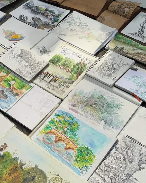 A flat lay of many of my sketchbooks, filled with drawings from various live sketching sessions. Each book holds countless memories and miles of lines.