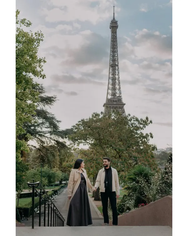 A quiet moment together on the steps of Paris, with the Eiffel Tower standing tall. This destination pre-wedding portrait captures the classic romance of the city.