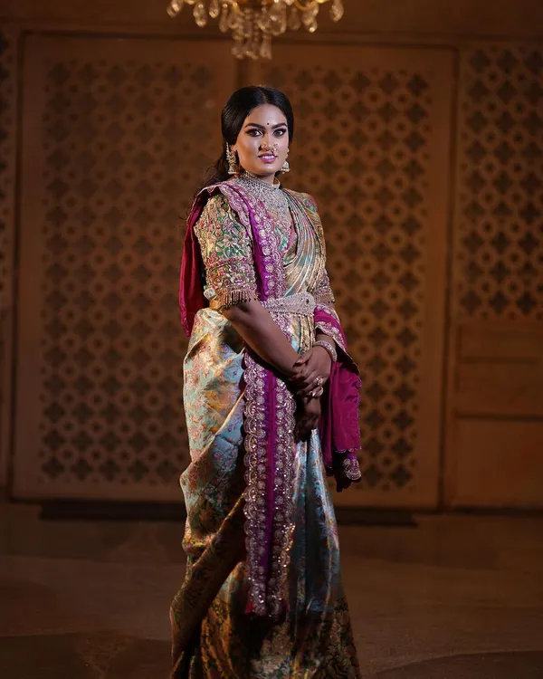 A regal portrait session for a client, featuring a stunning hand-embroidered blouse and a beautiful Kanjeevaram saree. The makeup was designed to give a royal, timeless feel.