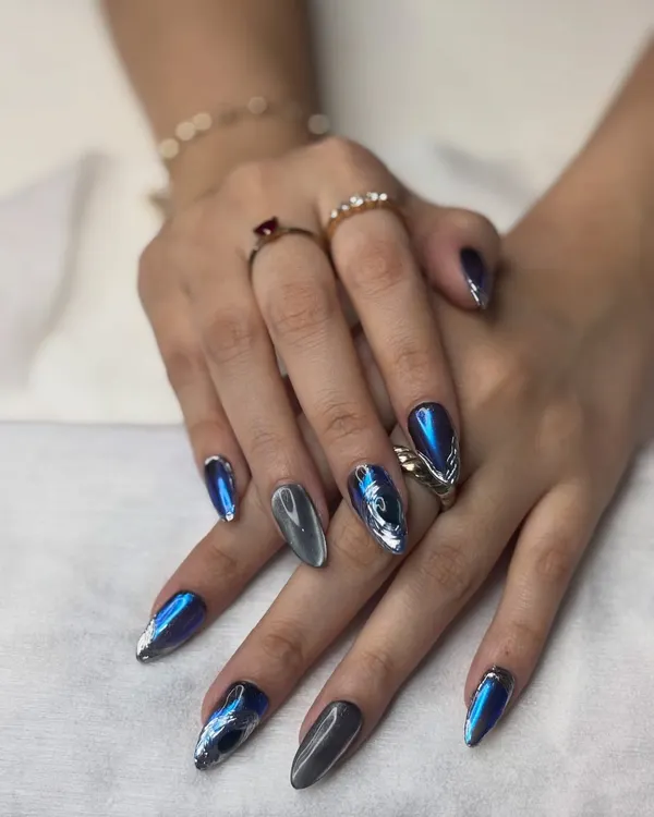This is the kind of nail art that gets everyone talking. I combined a deep blue and metallic silver chrome with a magnetic cat eye effect to create this futuristic, multi-dimensional look on long almond-shaped extensions. The way the light catches the different layers is just amazing.