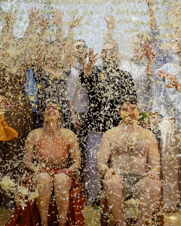 A moment of absolute joy as Dhwani and David are showered with flower petals during their Goa Haldi. This is the kind of happy, chaotic energy we love to capture.