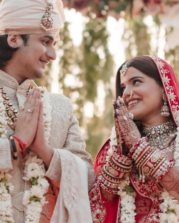 A beautiful moment from the wedding ceremony, where the bride and groom's henna-adorned hands come together in prayer.