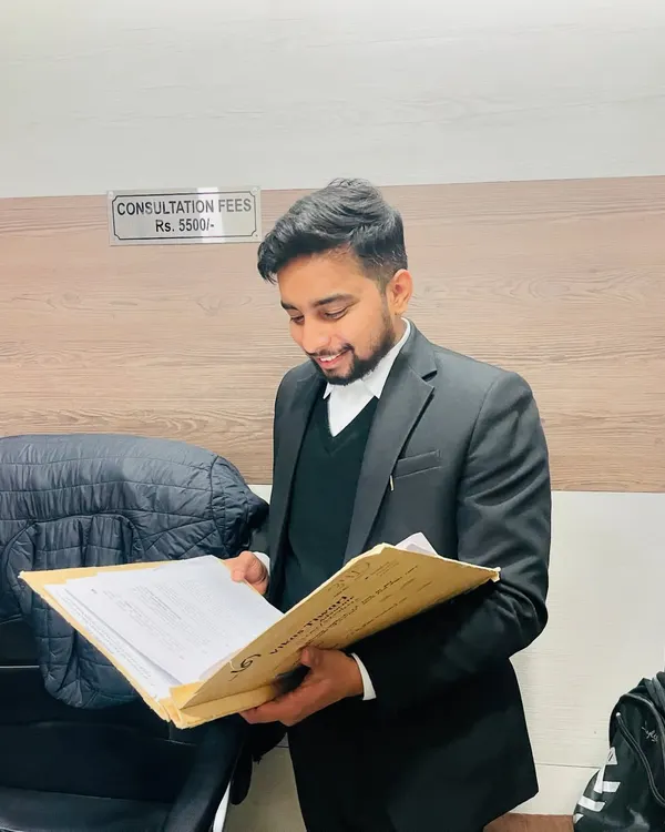 A lawyer's legacy is defined by the lives they touch and the principles they uphold. Here I am in my office, reviewing a case file with the consultation fee structure visible for transparency.
