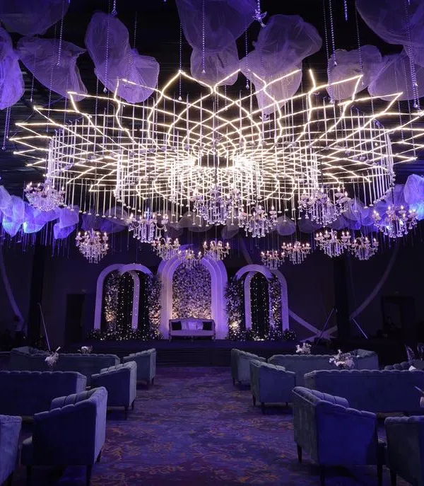 For a truly spectacular Sangeet, I designed this massive, lotus-shaped LED and crystal chandelier installation that served as the centerpiece of the entire ballroom, creating a futuristic yet elegant atmosphere.