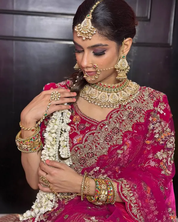 A classic North Indian bridal look featuring a dramatic smokey eye and bold jewelry. I focus on creating sharp, defined features that photograph beautifully while ensuring the skin looks radiant, not heavy.