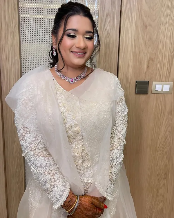 A celestial-themed sangeet or reception look. I created a textured, curly ponytail to go with her ethereal white outfit.