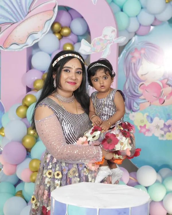 Our lovely client Annu celebrating her daughter's birthday. She chose a simple and elegant silver-finish choker that looks beautiful with her modern dress.