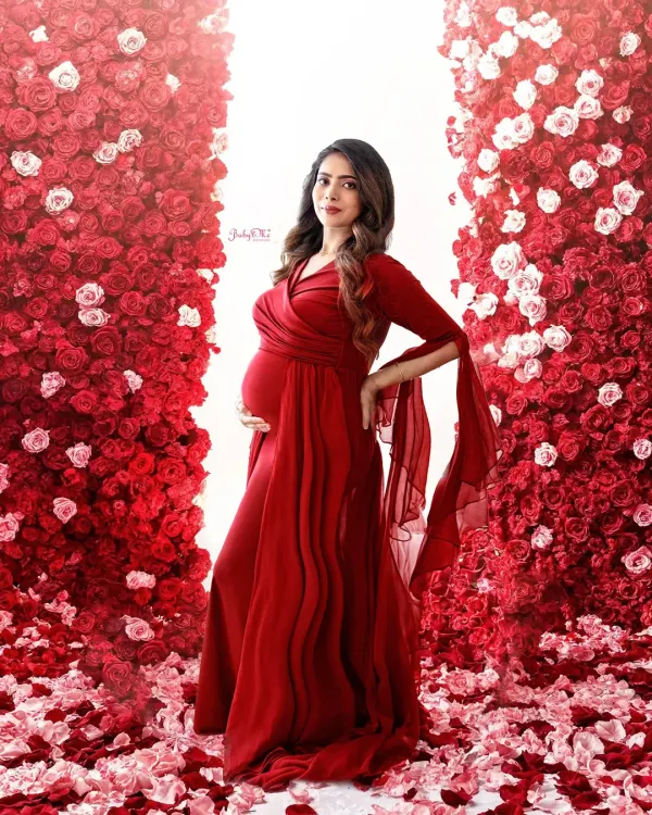 This stunning mama-to-be is surrounded by a wall of red roses, wearing one of my favorite dramatic gowns. I love creating these powerful, magazine-worthy portraits that celebrate the beauty of pregnancy.