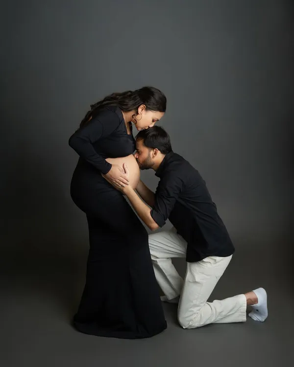 A classic and tender pose that I love to capture. The dad-to-be kneeling to kiss the baby bump is a powerful symbol of love and anticipation for their new arrival.