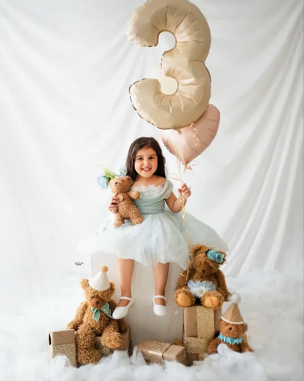 Celebrating a third birthday with a sky full of balloons and a party of teddy bears! This little princess is all smiles for her special milestone photoshoot.