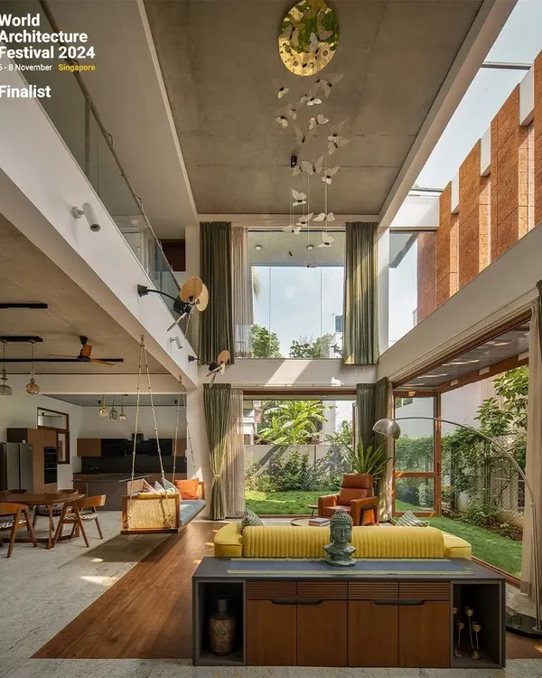 This is the heart of my "House of Greens" project, a space designed to feel like an open pavilion. The double-height volume, exposed concrete ceiling, and full-length doors dissolve the barrier between the home and the garden, embodying my philosophy of connecting life with nature.