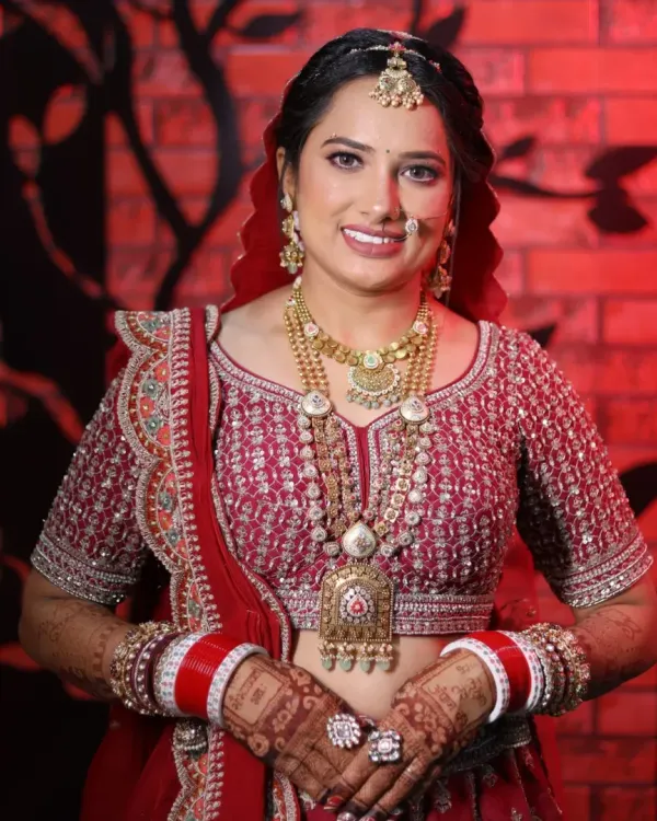 This is the quintessential radiant bridal look I love to create. For this beautiful Gujarati bride, we focused on luminous skin, soft brown eyes, and a classic red lip to perfectly complement her traditional attire and heavy jewelry, ensuring she felt confident and looked timeless on her wedding day.