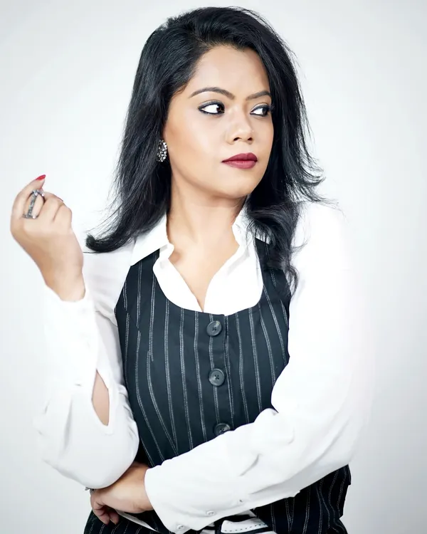 A crisp white shirt paired with a pinstripe waistcoat creates a sharp, professional look. This is a classic power dressing combination that communicates authority and style.
