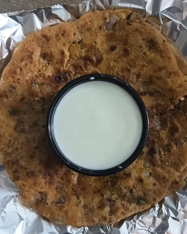 My special Mix Paratha, stuffed with a savory filling and served with a side of cool curd. It's a wholesome and filling meal in itself.