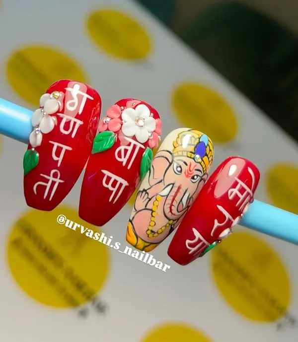 This Ganpati Bappa nail set is a piece of art. It features a hand-painted portrait of Ganesha, the 'Ganpati Bappa Morya' mantra in Hindi script, and 3D flowers. This is the level of detail and devotion we can bring to our nails.