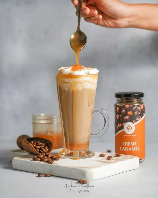 A decadent caramel drizzle being poured over a Crème Caramel iced coffee. Action shots like this are my specialty, creating a dynamic and mouth-watering image that captures the essence of the drink.