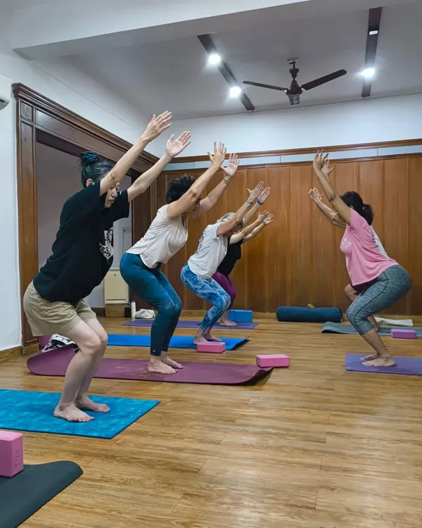 The powerful energy of a group practicing Utkatasana, or chair pose. In my classes, we build strength and stamina together, motivating each other every step of the way.
