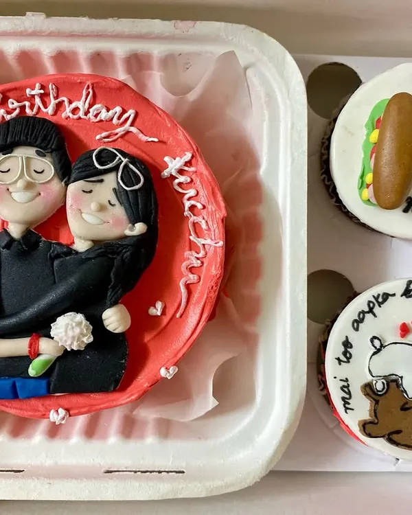 This custom gift box is what we live for. We created a hand-sculpted fondant topper of the couple for their bento cake and designed matching cupcakes with their inside jokes, like 'our forever 3 am meal'.