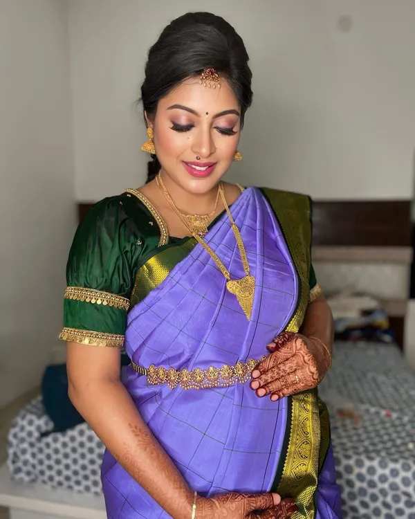 A beautiful close-up of this mom-to-be's baby shower makeup. We chose warm, glowing tones for her eyes and a soft lip color to highlight her happiness, ensuring the look was both traditional and comfortable for her seemantham.
