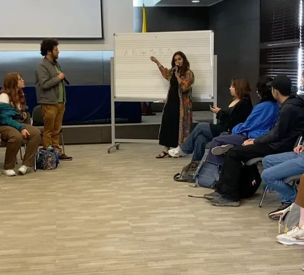 A typical workshop scene where I'm explaining the structure of a raga using a whiteboard. I find that visualizing the notes helps students grasp the melodic framework of Carnatic music more intuitively.