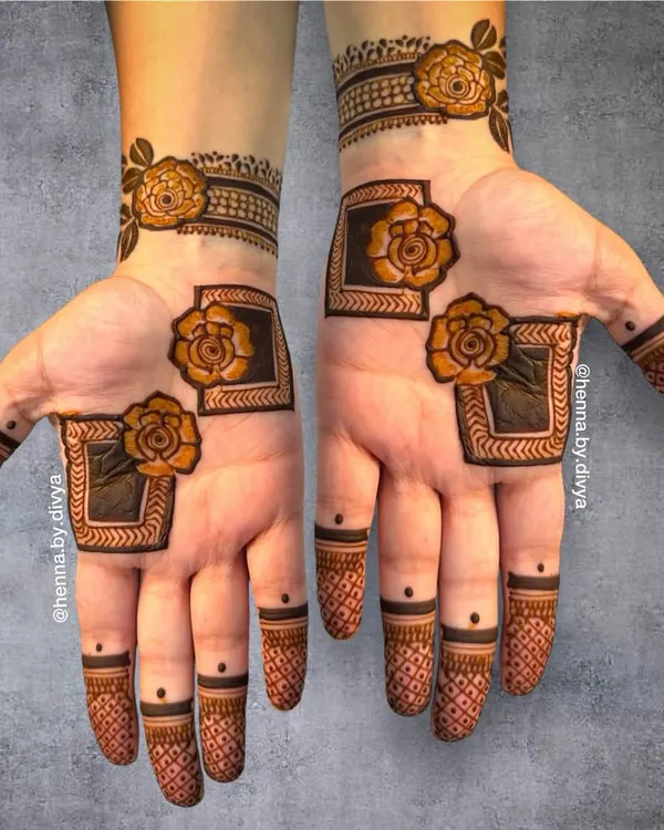 A modern and chic design featuring bold, framed roses. The use of negative space and clean lines gives this mehendi a very contemporary feel.